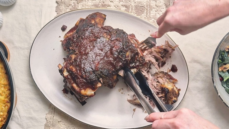 pulling lamb apart with a fork