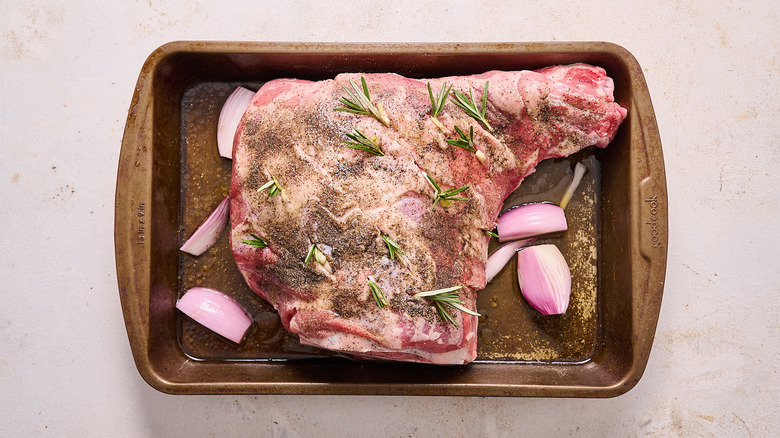 lamb in a roasting pan with white wine