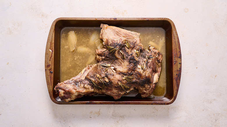 roasted lamb in a roasting pan