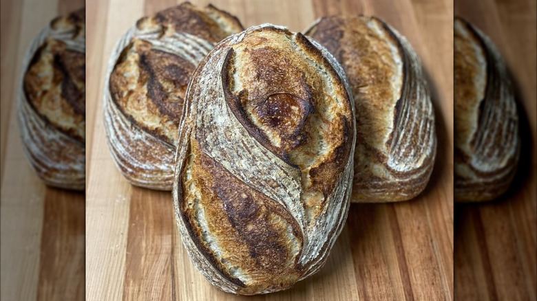 Three loaves of sourdough bread from Rustic Bread on wooden board