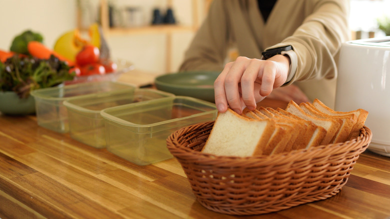 someone preparing to make sandwiches for lunch
