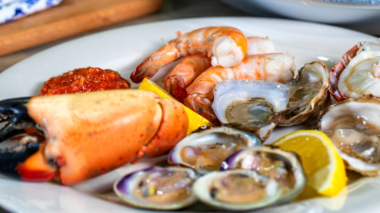 stone crabs, oysters and shrimp on white plate