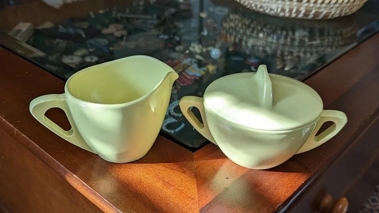 Light green Melmac sugar bowl and cream pitcher on wood table