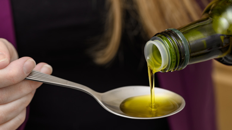 Pouring olive oil on a spoon