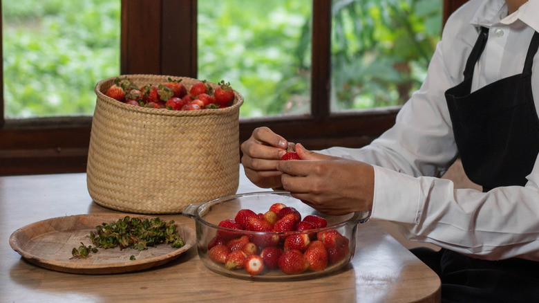chef hulling strawberries