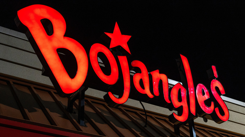 The illuminated exterior sign of a Bojangles restaurant location at night