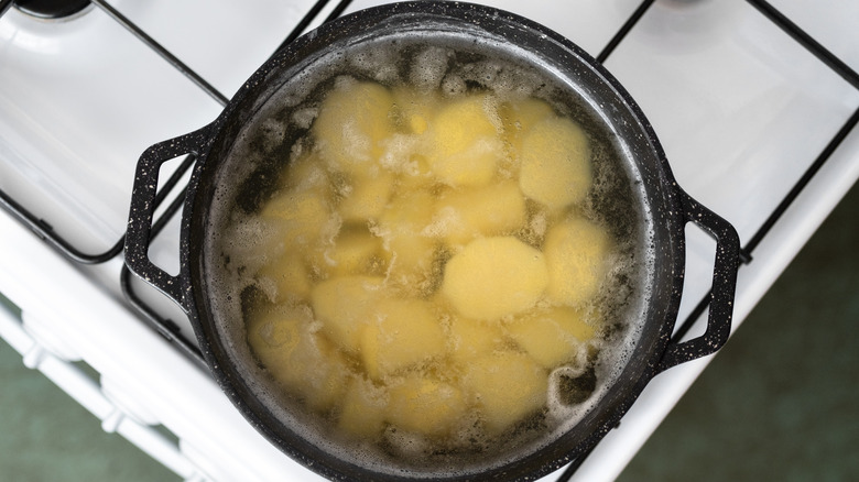 Potatoes boiling in a pot as seen from above