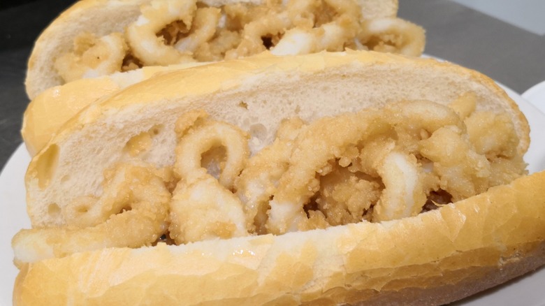 Pair of calamari sandwiches featuring crispy fried squid and white buns