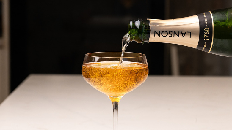pouring champagne into a glass