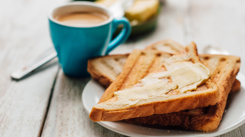 breakfast with buttered toast and cup of coffee or tea
