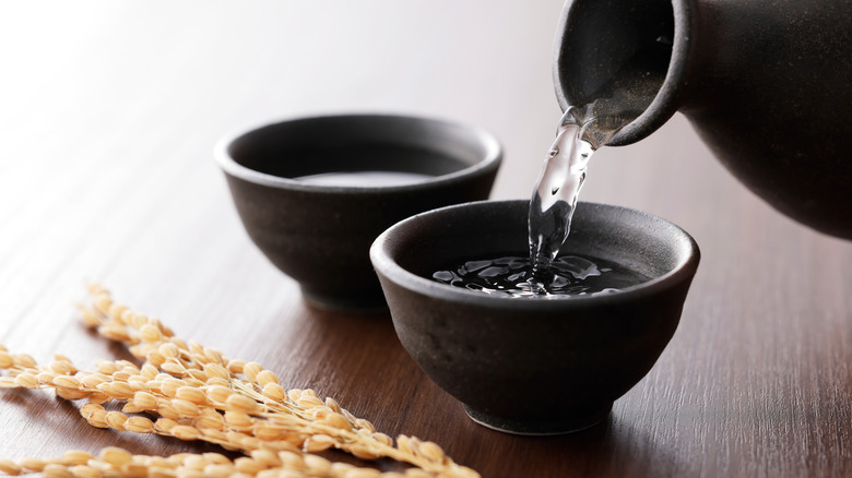 Sake pouring into traditional cup
