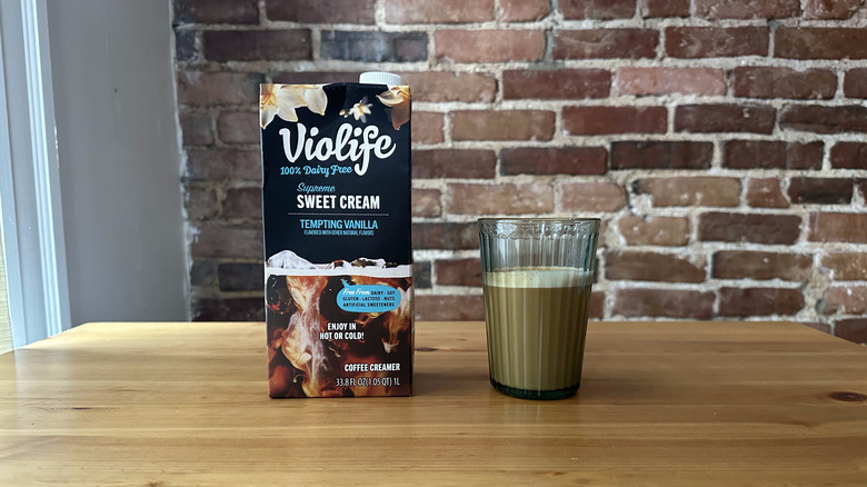 a carton of Violife sweet cream coffee creamer and glass of it