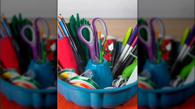 Blue bundt pan filled with office supplies