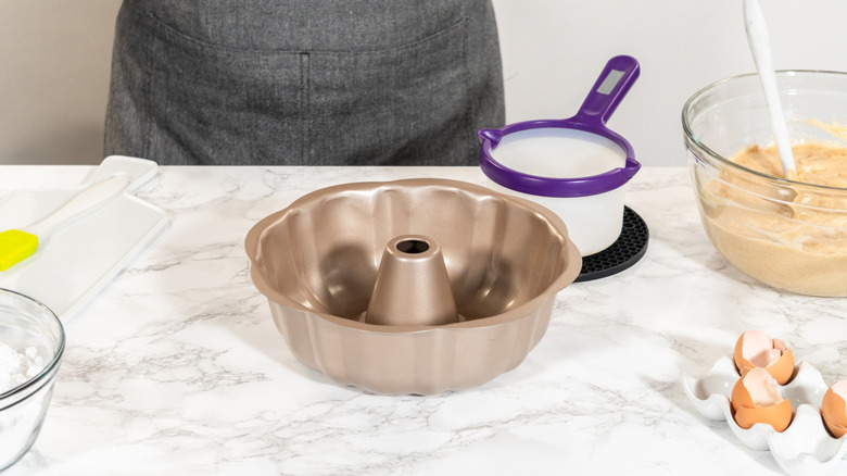 Bundt pan on counter with other baking supplies