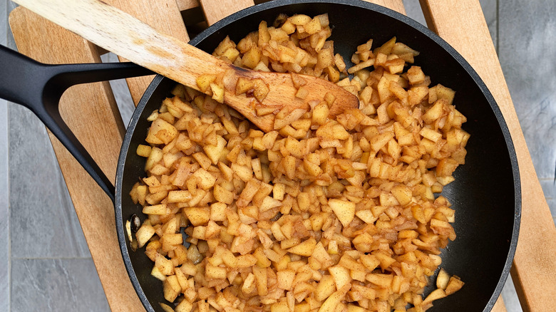 Apples in a pan with a spoon