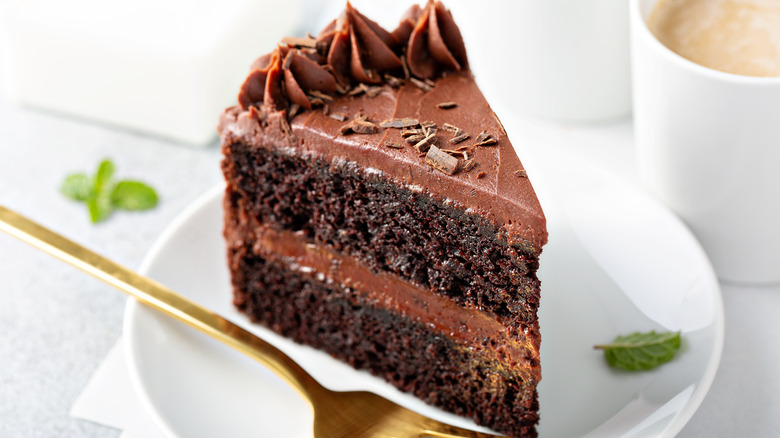 piece of chocolate cake with rich chocolate smooth buttercream frosting