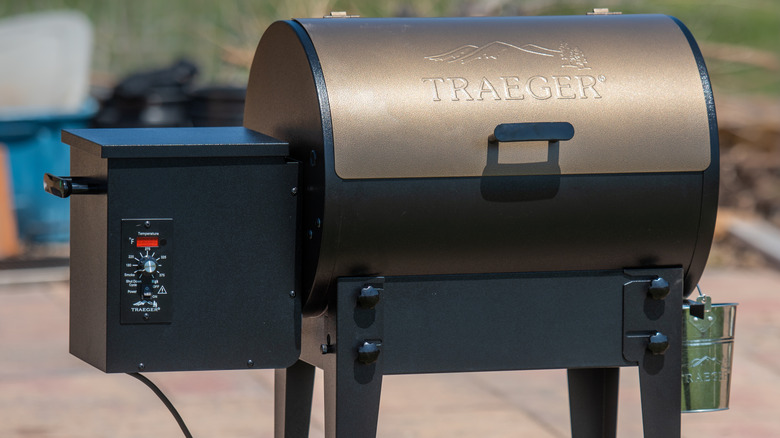 A Traeger brand wood pellet grill outside on patio