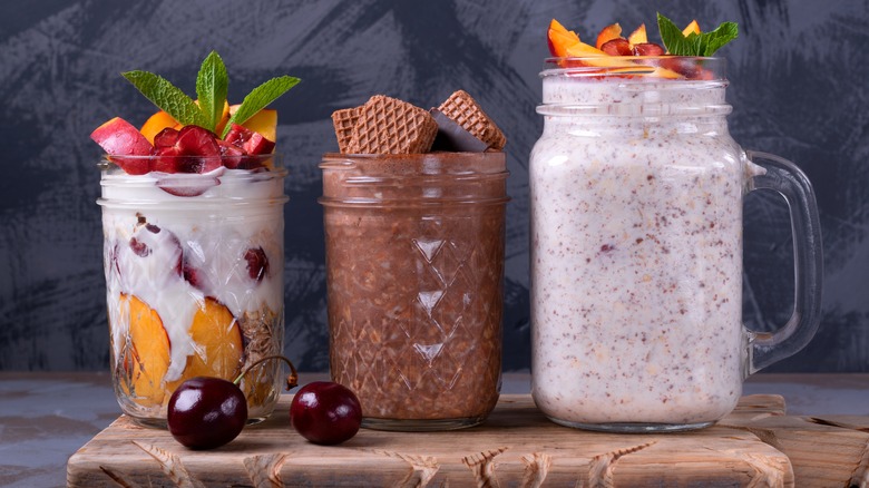 selection of overnight oats in jars on wood board
