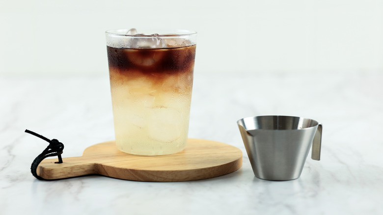 coconut cloud coffee in a glass on a wood board