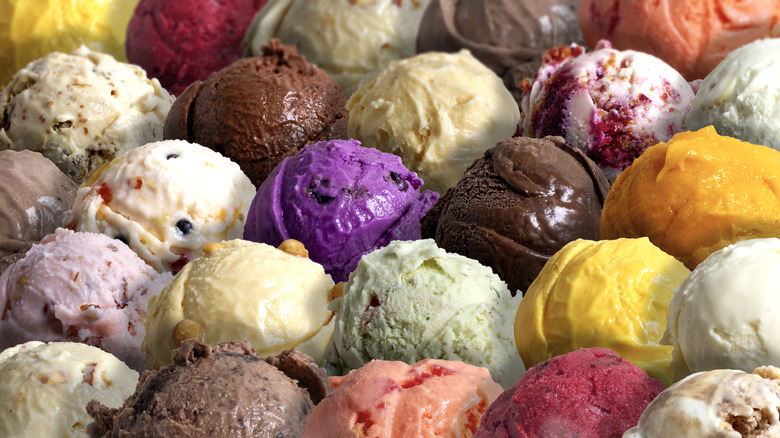 Scoops of different, colorful ice cream flavors sit side by side.