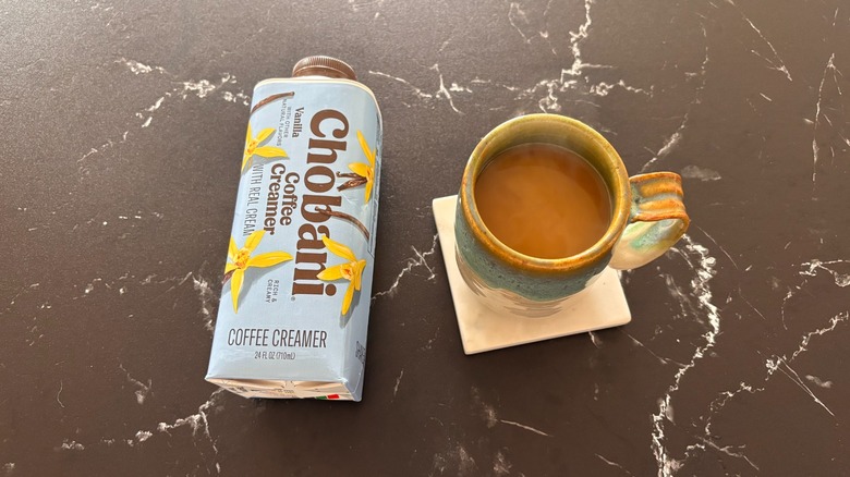 Chobani Vanilla Coffee Creamer beside a mug of coffee