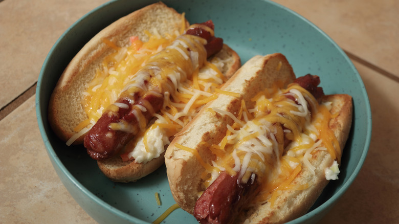 Hot dogs topped with hot slaw and cheese