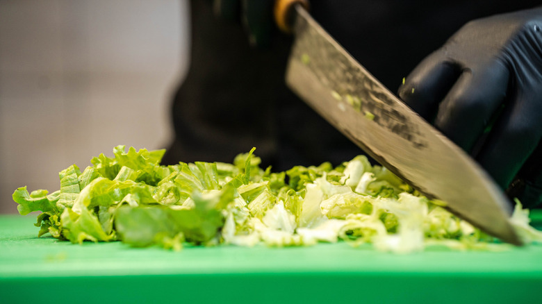 Sliced iceberg lettuce on cutting board