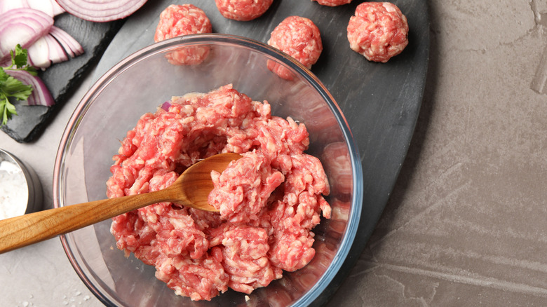 raw ground meat with onion slices