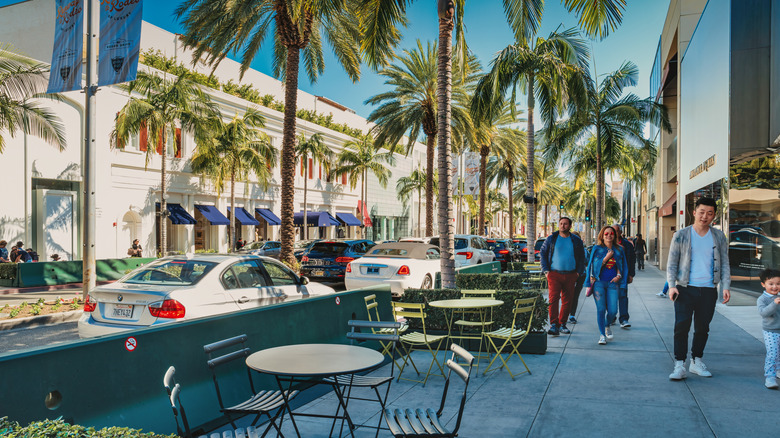People walk past stores on Rodeo Drive in Beverly Hills