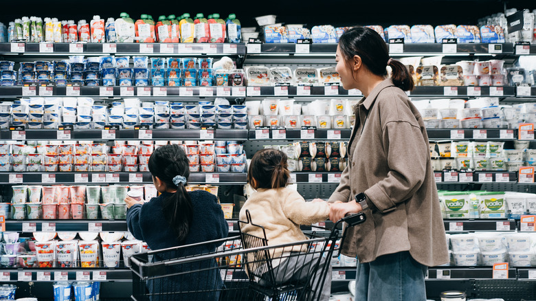 shopper looking at yogurts