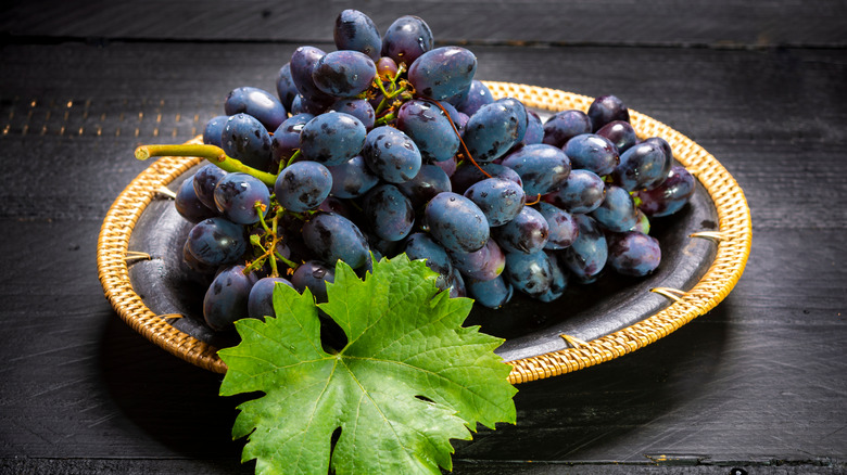 Grapes on a plate on dark table