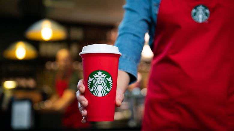 Starbucks red cup on wooden table