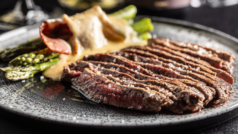 plate of marinated steak with asparagus
