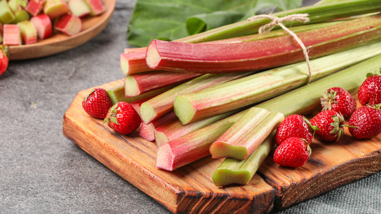 strawberries and rhubarb on wood board