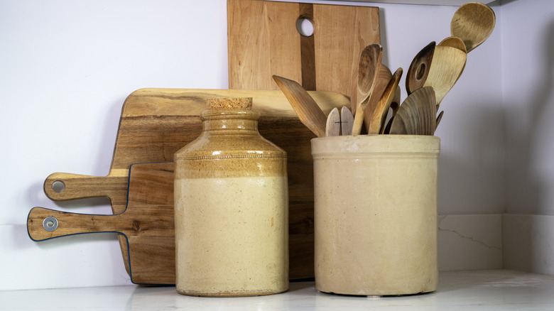 kitchen utensils in a vintage ceramic crock