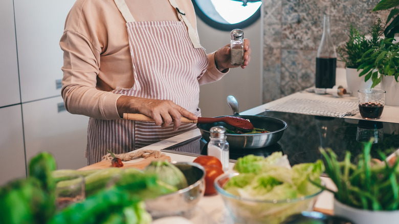 person cooking dinner on stove