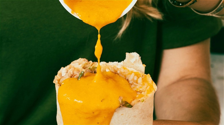 Dripping queso on a burrito