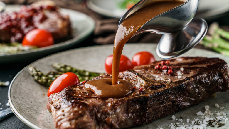 pouring sauce on seared steak