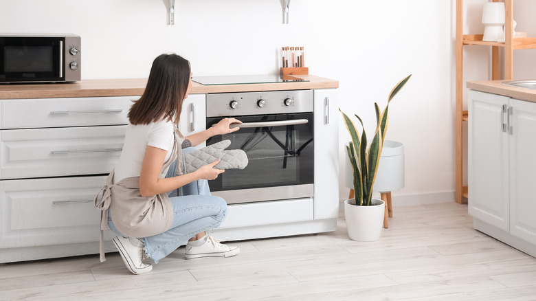 Women opening oven