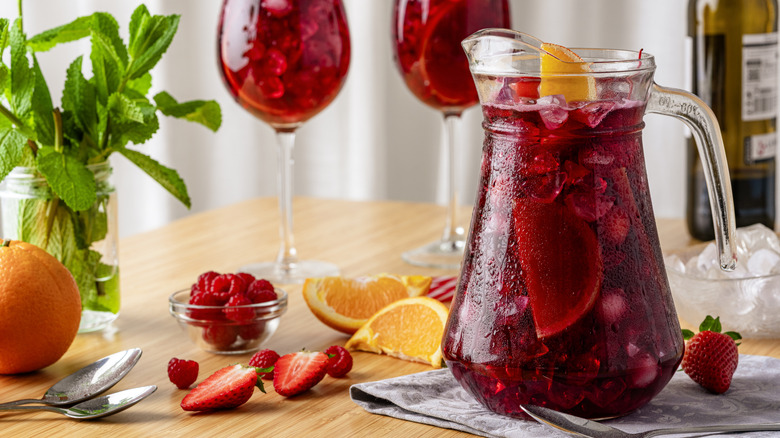Sangria in a pitcher and poured into glasses.