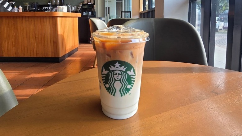 an iced caramel macchiato from starbucks on a table