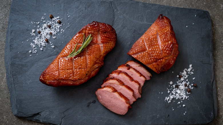 cooked duck breast, sliced and whole