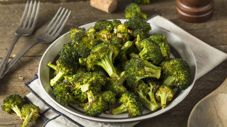 broccoli in white dish with two forks
