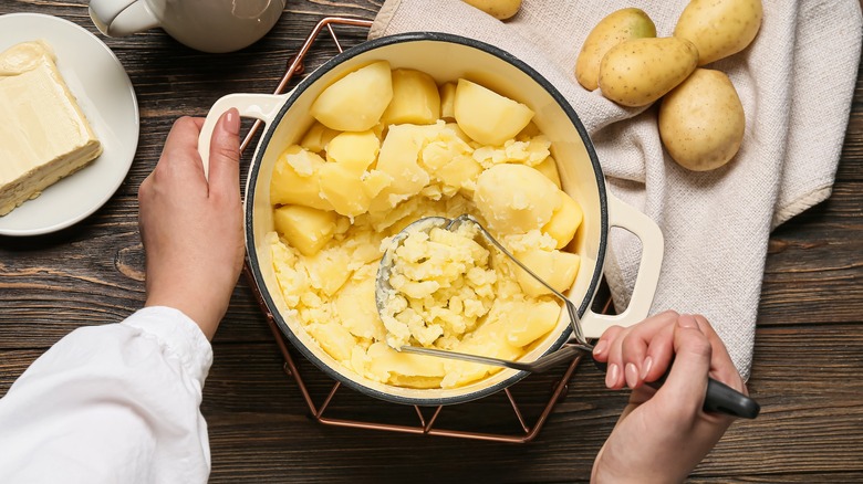person preparing mashed potatoes