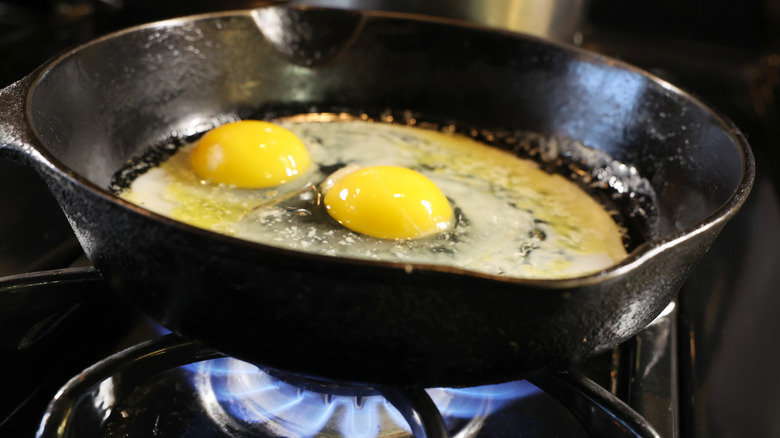 eggs frying in cast iron pan