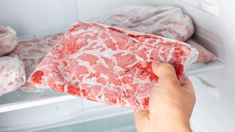 pulling frozen meat out of the freezer