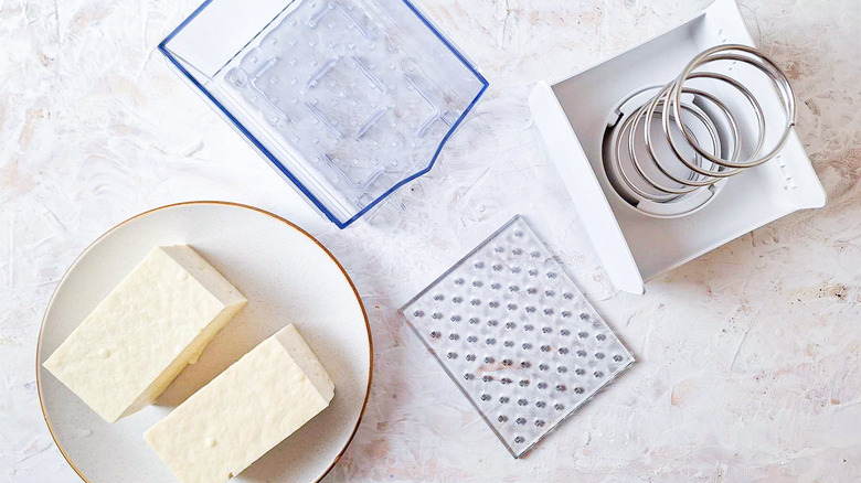 Tofu with unassembled tofu press