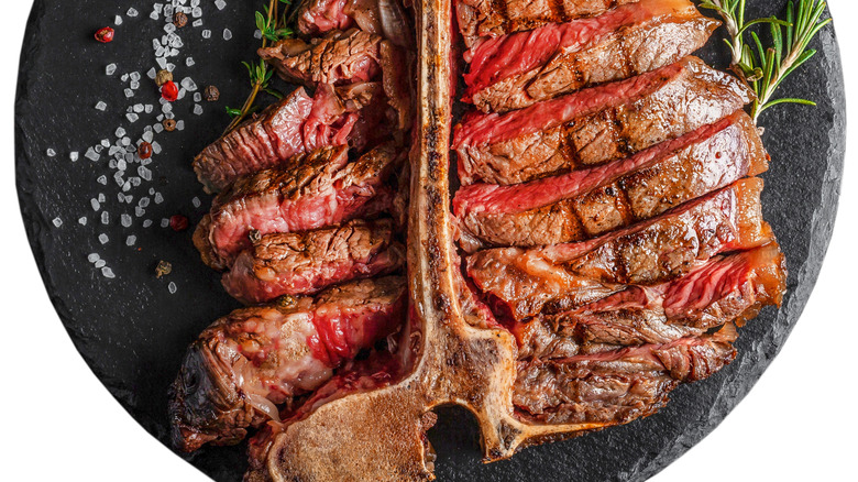 cooked porterhouse steak on a marble slab