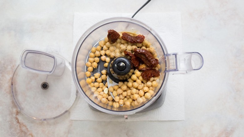 Chickpeas and sun-dried tomatoes in food processor