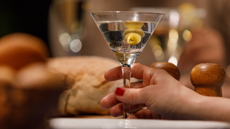manicured hand holding martini 